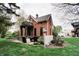 Charming red brick home featuring a cozy patio, lush green lawn, and delightful outdoor seating at 301 Lowry St, Jamestown, IN 46147