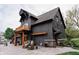 Modern gray home with a balcony, stone accents, a spacious driveway, and stylish outdoor seating at 301 Lowry St, Jamestown, IN 46147