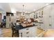 Elegant kitchen with a large center island, light-gray cabinets, and a vintage-style chandelier at 301 Lowry St, Jamestown, IN 46147