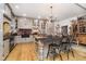 Modern kitchen featuring gray cabinets, hardwood floors, a brick backsplash, and a center island at 301 Lowry St, Jamestown, IN 46147