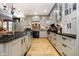 Beautifully designed kitchen featuring light-gray cabinetry, hardwood floors, and a brick-accented range at 301 Lowry St, Jamestown, IN 46147