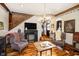 Inviting living room with hardwood floors, brick fireplace, and staircase at 301 Lowry St, Jamestown, IN 46147
