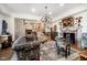 Bright living room featuring a brick fireplace, stylish sofas, and an open view to the kitchen area at 301 Lowry St, Jamestown, IN 46147