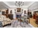 Charming living room featuring a brick fireplace, wooden floors, a stylish rug, and unique vintage decor at 301 Lowry St, Jamestown, IN 46147