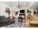 Comfortable living room with patterned sofas, a flat screen TV, hardwood floors, and traditional decor at 301 Lowry St, Jamestown, IN 46147