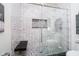 Modern shower featuring white subway tile, a mosaic-tiled floor, and a built-in shower seat and niche at 301 Lowry St, Jamestown, IN 46147