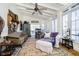 Bright and airy sunroom featuring large windows, a ceiling fan, and comfortable seating at 301 Lowry St, Jamestown, IN 46147