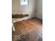 Bedroom featuring hardwood floors and water damaged walls, awaiting renovation at 3048 Newton Ave, Indianapolis, IN 46201