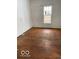 A bedroom with light hardwood floors and bright natural light at 3048 Newton Ave, Indianapolis, IN 46201