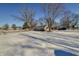 House with snow covered yard and trees at 308 E 54Th St, Anderson, IN 46013