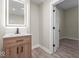 Modern bathroom with a lighted vanity and neutral color palette at 317 N Belleview Pl, Indianapolis, IN 46222