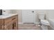 Stylish bathroom with wood vanity, white toilet, and modern flooring at 317 N Belleview Pl, Indianapolis, IN 46222