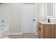 Clean bathroom featuring a white bathtub, wood vanity, and updated hardware at 317 N Belleview Pl, Indianapolis, IN 46222