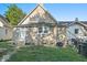 Tan house exterior with a back door, two windows, and a small yard at 317 N Belleview Pl, Indianapolis, IN 46222