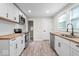 Modern kitchen with white shaker cabinets, butcher block countertops, and stainless steel appliances at 317 N Belleview Pl, Indianapolis, IN 46222