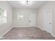 Light and airy living room with neutral walls and wood-look flooring at 317 N Belleview Pl, Indianapolis, IN 46222