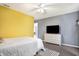 Bedroom with yellow accent wall and ceiling fan at 3174 Hemlock St, Whiteland, IN 46184