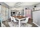 Bright dining area with a wooden table, white chairs and view into the living room at 3174 Hemlock St, Whiteland, IN 46184