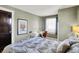 Bedroom featuring decorative pillows, stylish desk and chair and view of the front yard through the window at 5210 E Pleasant Run Parkway North Dr, Indianapolis, IN 46219