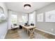 Bright home office features wood desk, hardwood floors, and large windows at 5326 Noble Crossing W Pkwy, Noblesville, IN 46062