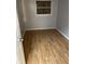 Simple bedroom with wood-look floors and a window at 5778 E 30Th St, Indianapolis, IN 46218