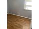 Simple bedroom with gray walls and laminate wood flooring at 5778 E 30Th St, Indianapolis, IN 46218