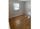 Bright bedroom with gray walls and laminate wood flooring at 5778 E 30Th St, Indianapolis, IN 46218