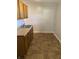 Galley kitchen with wood cabinets, double sink, and tiled floor at 5778 E 30Th St, Indianapolis, IN 46218