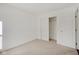 Bedroom with closet and door, featuring neutral carpet at 5872 Lost Oaks Dr, Carmel, IN 46033