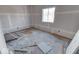 Unfinished bedroom with exposed flooring and debris at 605 Hendricks St, Anderson, IN 46016