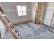 Unfinished bedroom with exposed flooring and ladder at 605 Hendricks St, Anderson, IN 46016