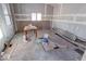 Under construction, dining room with hardwood floors and window at 605 Hendricks St, Anderson, IN 46016