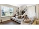 Tan sectional sofa, hardwood floors, and large window in living room at 7255 Barker St, Carmel, IN 46033