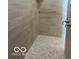 Walk-in shower with beige tile and pebble floor at 7419 Legends Way, Whitestown, IN 46052