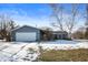 Gray house with white garage door, stone pillars, and a partially snow-covered yard at 8105 N Myers Rd, Muncie, IN 47303