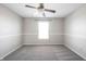 Simple bedroom with neutral walls, carpet, ceiling fan, and a window at 9286 W Quarter Moon Dr, Pendleton, IN 46064