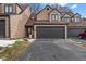 Attractive exterior of a two-story townhome with a large dark gray garage door at 9649 Highgate N Cir, Indianapolis, IN 46250