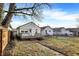 Backyard with a small wooden deck, fence, and grass at 1028 Albany St, Indianapolis, IN 46203