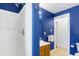 Clean bathroom with white shower, vanity, and blue accent wall at 1028 Albany St, Indianapolis, IN 46203