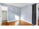 Cozy bedroom with light blue walls, white trim, and decorative geometric wall accent at 1028 Albany St, Indianapolis, IN 46203