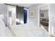 Inviting bedroom with a sliding barn door leading to the bathroom and a comfortable view into the living room at 1028 Albany St, Indianapolis, IN 46203