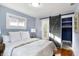Comfortable bedroom featuring a sliding barn door, creating a private transition to the ensuite bathroom and closet at 1028 Albany St, Indianapolis, IN 46203