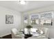 Dining area with modern glass table, white chairs, and bright natural light at 1028 Albany St, Indianapolis, IN 46203