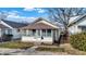 Charming single-story home with a porch, well maintained lawn, and beautiful landscaping at 1028 Albany St, Indianapolis, IN 46203