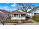 Charming single-story home with a porch, well maintained lawn, and beautiful landscaping at 1028 Albany St, Indianapolis, IN 46203