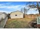View of detached garage with siding, door, small window, and a small fenced in yard at 1028 Albany St, Indianapolis, IN 46203