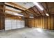Spacious garage featuring concrete floor, wood stud walls, overhead lighting and garage door at 1028 Albany St, Indianapolis, IN 46203