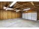 Spacious garage featuring concrete floor, wood stud walls, overhead lighting and garage door at 1028 Albany St, Indianapolis, IN 46203