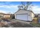 View of detached garage with a white garage door, vinyl siding, and fenced yard at 1028 Albany St, Indianapolis, IN 46203