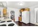Bright kitchen features wooden cabinets, white appliances, and view to living room at 1028 Albany St, Indianapolis, IN 46203